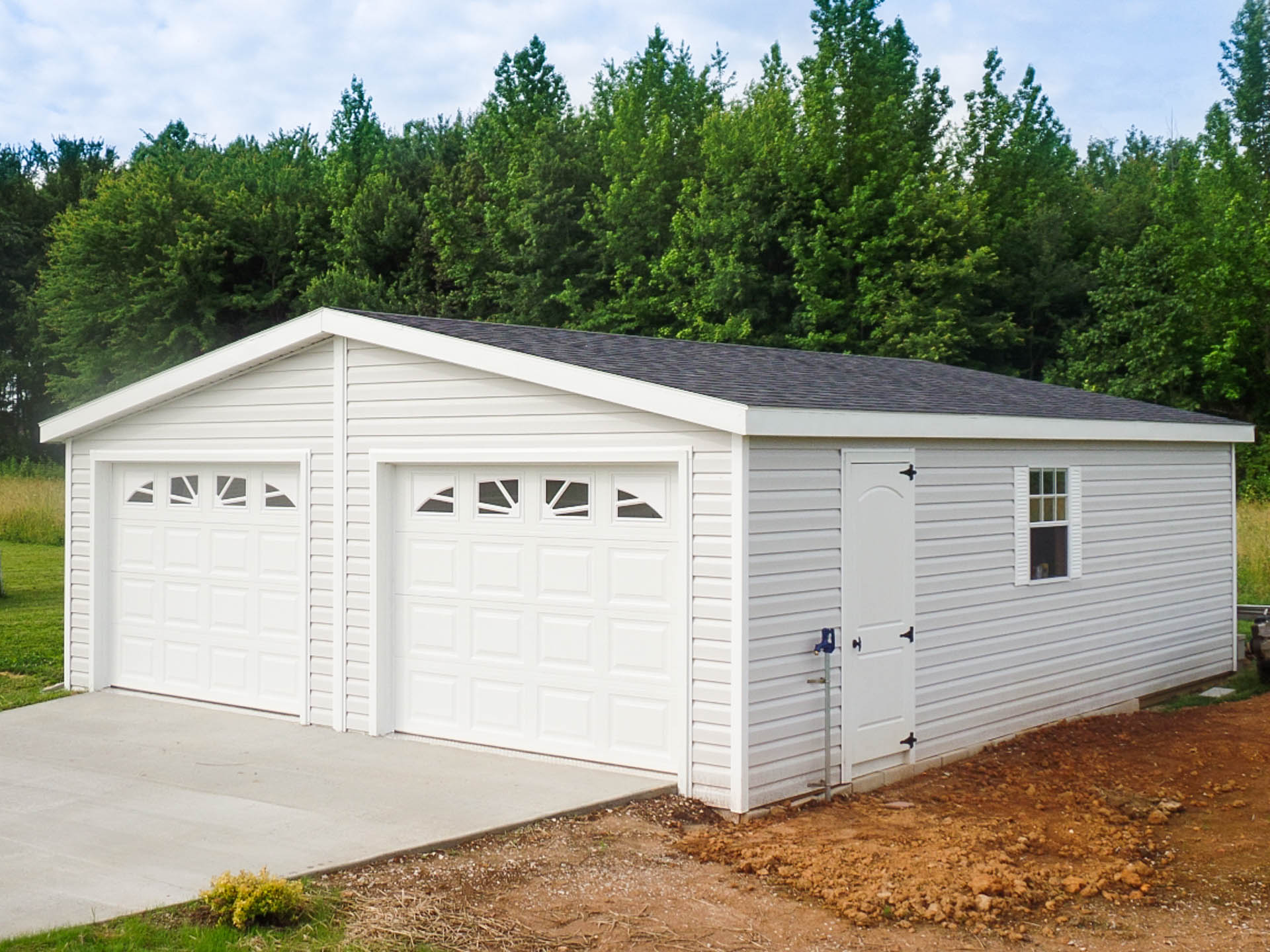 A double-wide modular garage with vinyl siding.
